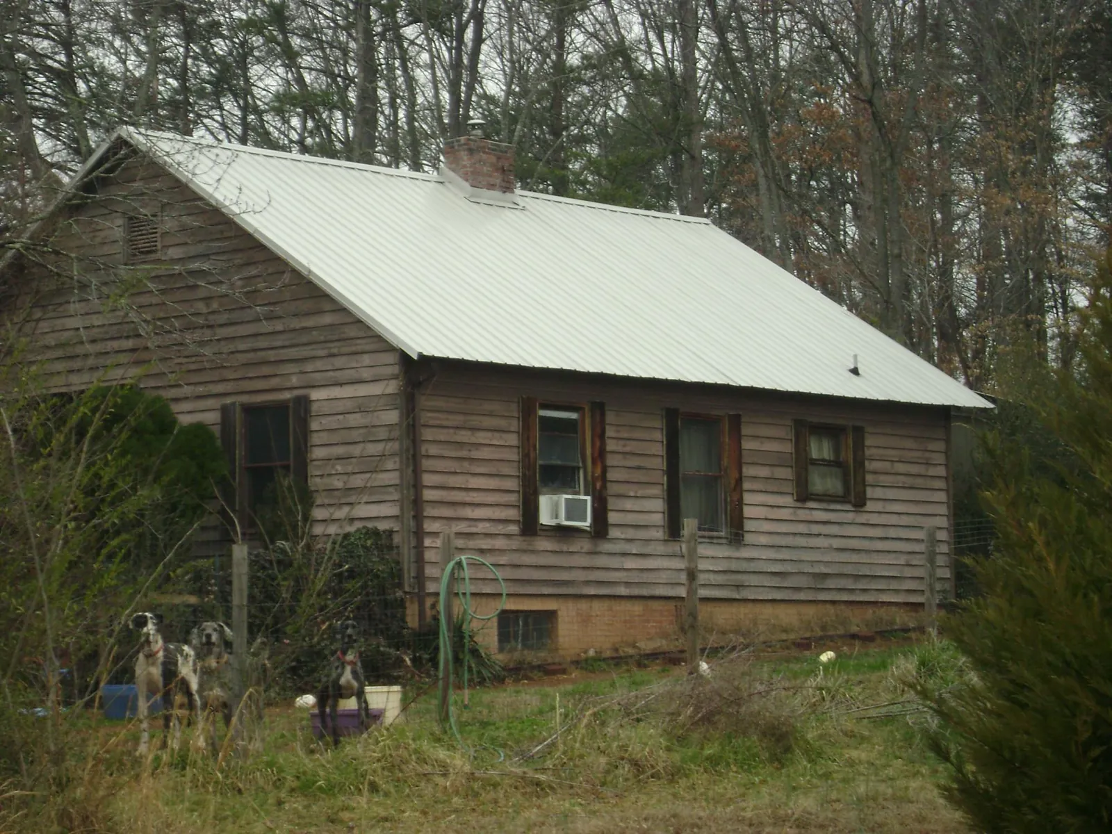 White metal roof on an old wood sided farmhouse, from a Metal Roof Installation job in Lansford